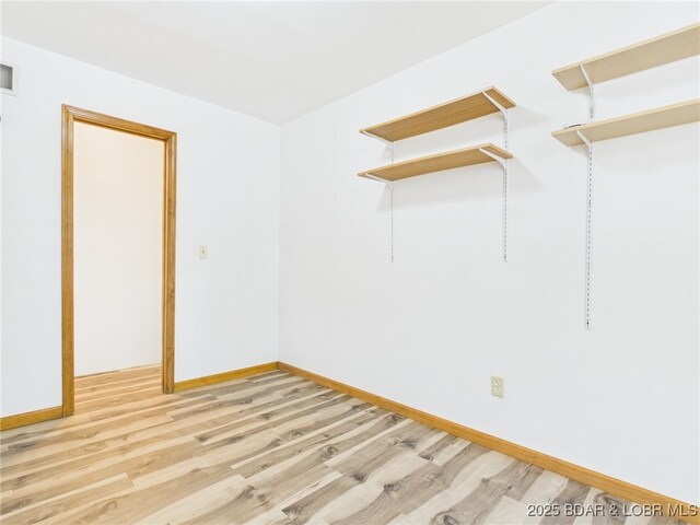 3760 Dogwood Dr, Stover, MO 65078 - spare room featuring light wood finished floors, visible vents, and baseboards