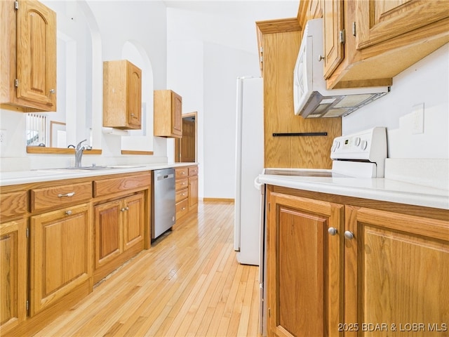 3760 Dogwood Dr, Stover, MO 65078 - kitchen featuring brown cabinets, a sink, white appliances, light countertops, and light wood-style floors