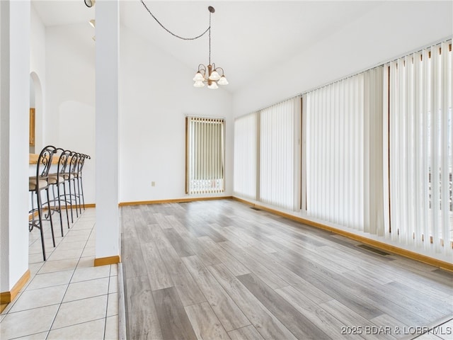 3760 Dogwood Dr, Stover, MO 65078 - interior space featuring an inviting chandelier, light wood-style floors, baseboards, and arched walkways