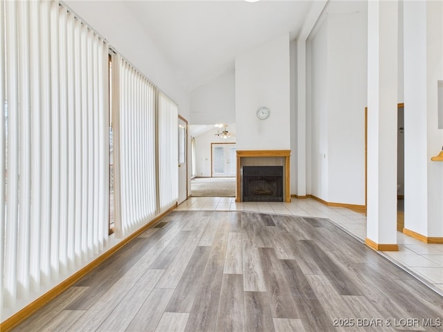 3760 Dogwood Dr, Stover, MO 65078 - unfurnished living room with ceiling fan, a fireplace with flush hearth, high vaulted ceiling, and wood finished floors