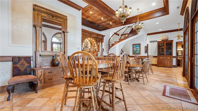 dining space with ornamental molding, light tile patterned flooring, a notable chandelier, and coffered ceiling