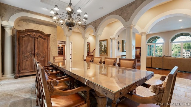 dining area with ornate columns, a chandelier, recessed lighting, and stone tile flooring
