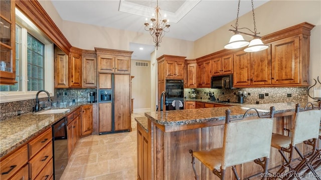 kitchen with brown cabinets, a sink, black appliances, and visible vents