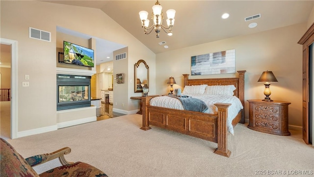 carpeted bedroom with a multi sided fireplace, a chandelier, and visible vents