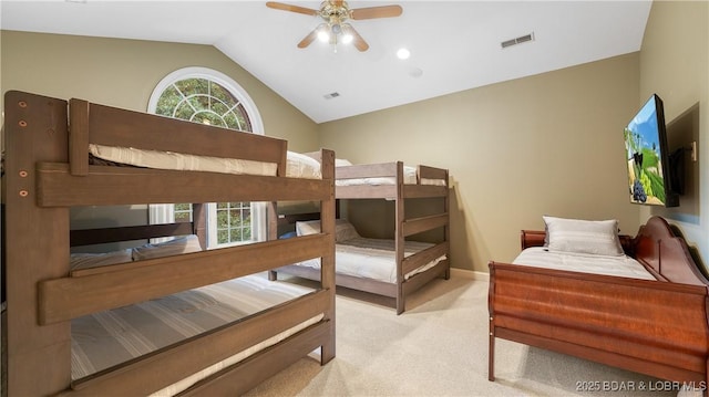 carpeted bedroom featuring multiple windows, visible vents, baseboards, and vaulted ceiling