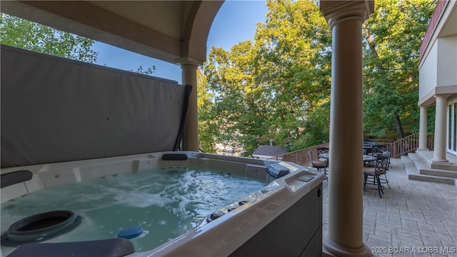 view of patio featuring outdoor dining space and a hot tub