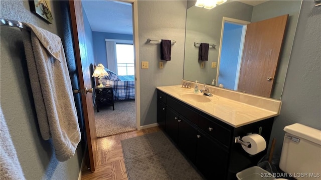 31347 Northshore Dr Unit 101A, Rocky Mount, MO 65072 - bathroom featuring toilet, vanity, a textured wall, and baseboards