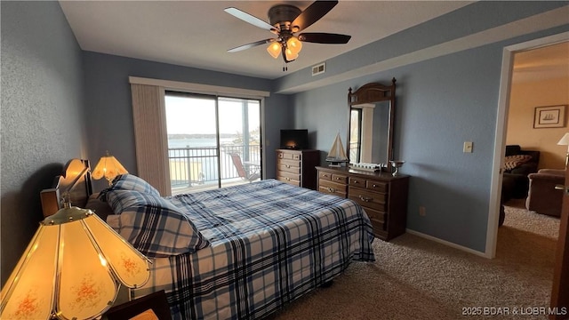 31347 Northshore Dr Unit 101A, Rocky Mount, MO 65072 - bedroom featuring visible vents, baseboards, a ceiling fan, access to exterior, and dark colored carpet
