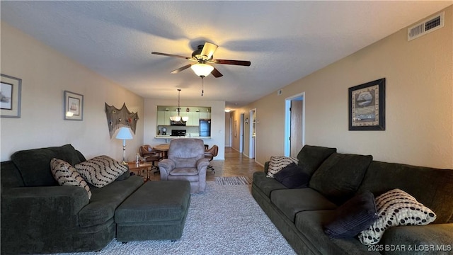 31347 Northshore Dr Unit 101A, Rocky Mount, MO 65072 - living area featuring a textured ceiling, visible vents, and a ceiling fan