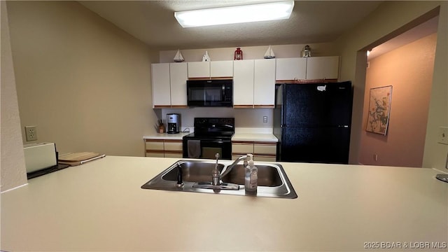 31347 Northshore Dr Unit 101A, Rocky Mount, MO 65072 - kitchen with a sink, white cabinetry, light countertops, and black appliances