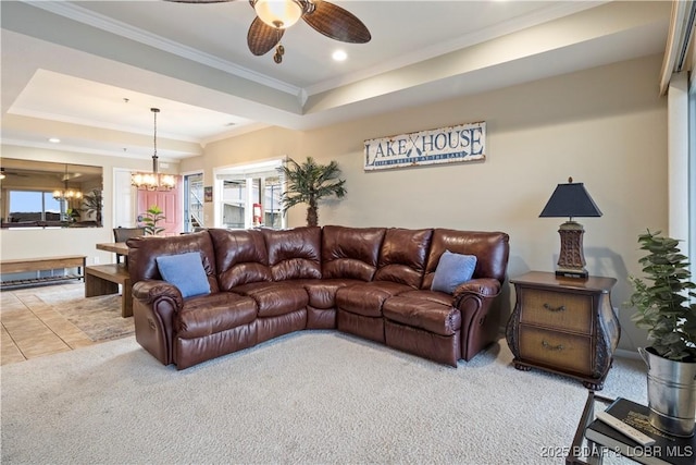 carpeted living area with a chandelier, ornamental molding, a raised ceiling, a ceiling fan, and recessed lighting