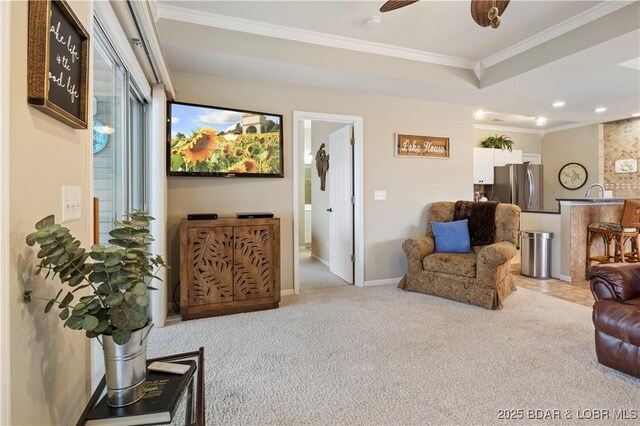 living area featuring ornamental molding, carpet floors, recessed lighting, ceiling fan, and baseboards