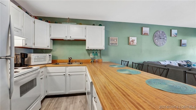 123 Southwood Shores Dr Unit 2B, Lake Ozark, MO 65049 - kitchen with white appliances, white cabinets, open floor plan, light wood finished floors, and wooden counters