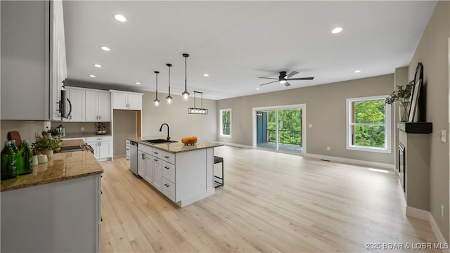 20311 Timberlake Village Ln, Rocky Mount, MO 65072 - kitchen featuring open floor plan, a sink, light wood finished floors, ceiling fan, and dishwasher