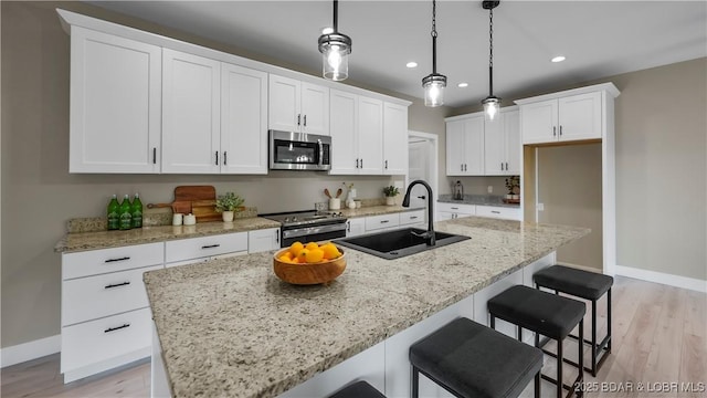 20311 Timberlake Village Ln, Rocky Mount, MO 65072 - kitchen featuring a sink, a center island with sink, stainless steel appliances, white cabinets, and recessed lighting