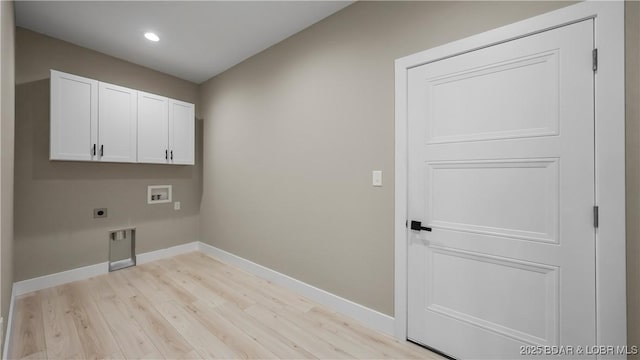 20311 Timberlake Village Ln, Rocky Mount, MO 65072 - laundry room with hookup for a washing machine, baseboards, light wood-style flooring, cabinet space, and electric dryer hookup
