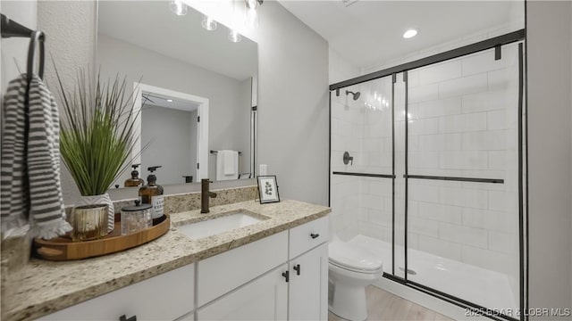 20311 Timberlake Village Ln, Rocky Mount, MO 65072 - bathroom with a stall shower, wood finished floors, toilet, and vanity