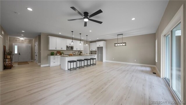 20311 Timberlake Village Ln, Rocky Mount, MO 65072 - living area featuring baseboards, light wood-type flooring, ceiling fan, and recessed lighting