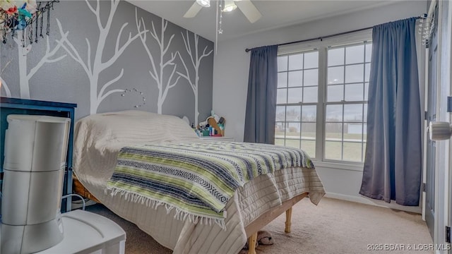 carpeted bedroom with a ceiling fan, multiple windows, and baseboards