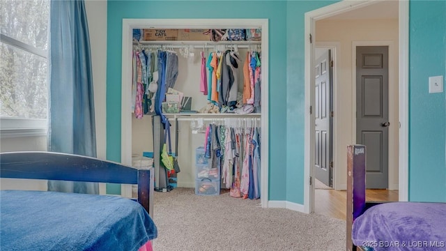bedroom featuring baseboards, carpet floors, and a closet