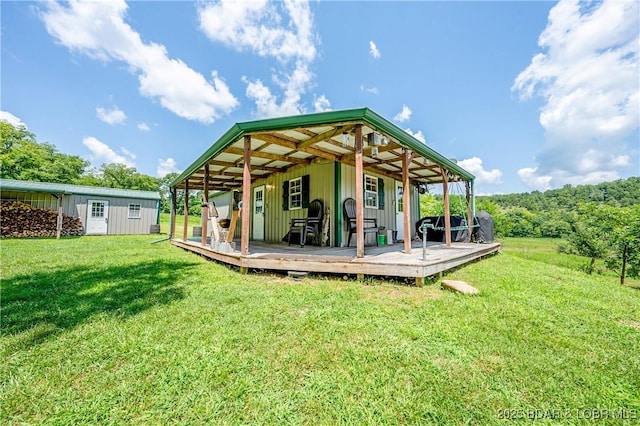 exterior space with a lawn, an outbuilding, and board and batten siding