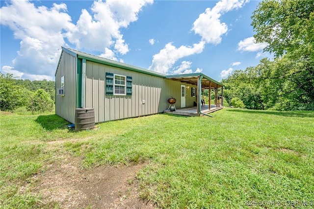 back of house featuring a lawn and board and batten siding