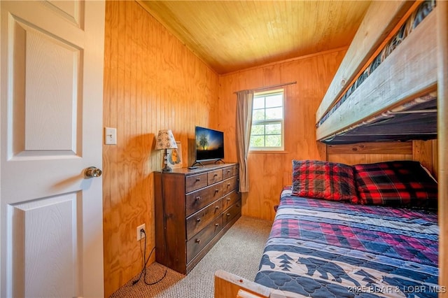 bedroom featuring wood ceiling, carpet, and wood walls