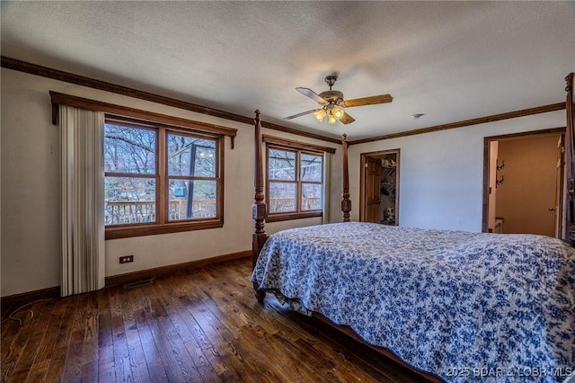 27394 Cross Ln, Barnett, MO 65011 - bedroom featuring dark wood finished floors, a textured ceiling, crown molding, and a ceiling fan