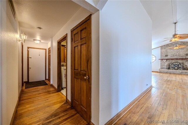 27394 Cross Ln, Barnett, MO 65011 - corridor with light wood-style flooring and washer / clothes dryer