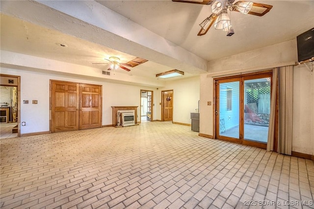 27394 Cross Ln, Barnett, MO 65011 - unfurnished living room with a ceiling fan and brick patterned flooring