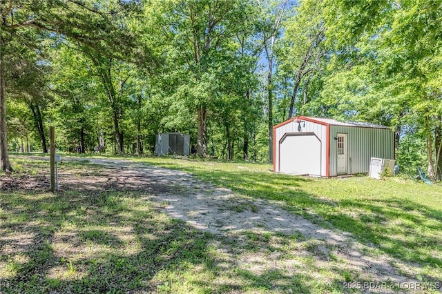 27394 Cross Ln, Barnett, MO 65011 - view of grassy yard featuring a garage and an outbuilding