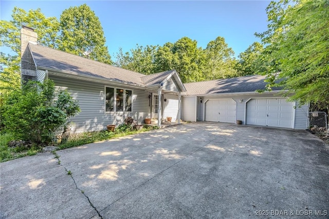 27394 Cross Ln, Barnett, MO 65011 - ranch-style house featuring concrete driveway, a garage, and a chimney