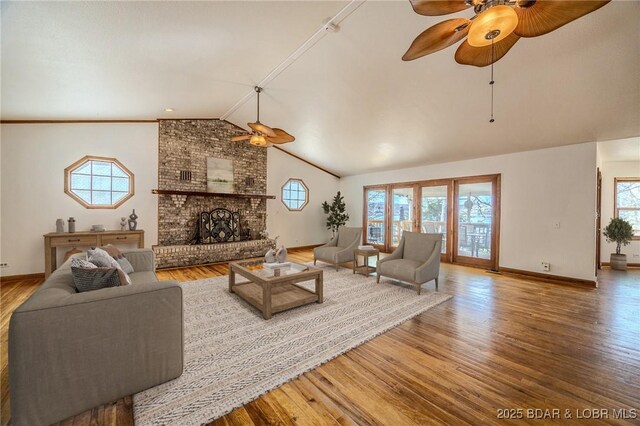 27394 Cross Ln, Barnett, MO 65011 - living area featuring a ceiling fan, wood finished floors, vaulted ceiling, and a brick fireplace