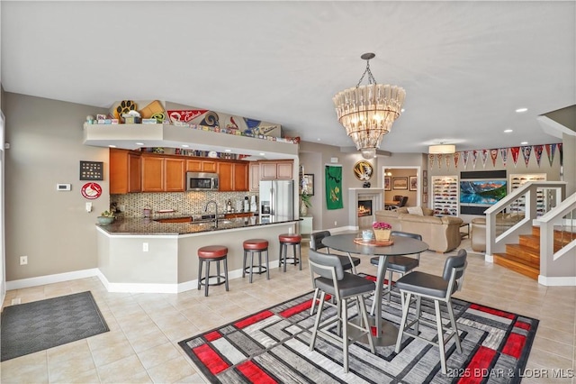 dining room with light tile patterned floors, baseboards, recessed lighting, a chandelier, and stairway