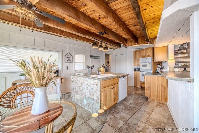 33271 Elaine Rd, Sunrise Beach, MO 65079 - kitchen with white appliances, ceiling fan, a sink, wooden ceiling with exposed beams, and light countertops