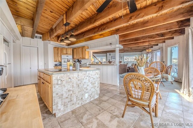 33271 Elaine Rd, Sunrise Beach, MO 65079 - kitchen with wooden ceiling with exposed beams, a chandelier, light countertops, a kitchen island, and double oven