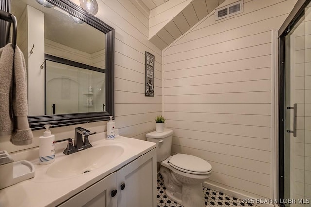 33271 Elaine Rd, Sunrise Beach, MO 65079 - full bathroom featuring wooden walls, toilet, a stall shower, and vanity