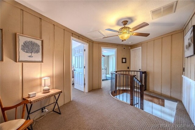 33271 Elaine Rd, Sunrise Beach, MO 65079 - corridor featuring a decorative wall, light colored carpet, an upstairs landing, and attic access