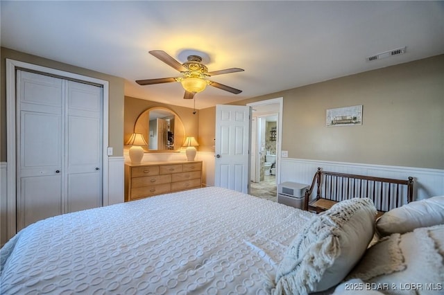 33271 Elaine Rd, Sunrise Beach, MO 65079 - bedroom with a wainscoted wall, a closet, and ceiling fan