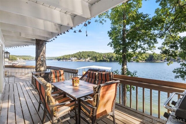 33271 Elaine Rd, Sunrise Beach, MO 65079 - wooden terrace featuring a water view and outdoor dining space