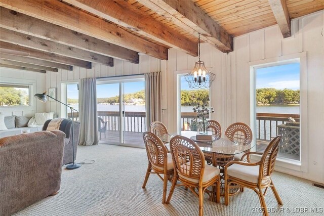 33271 Elaine Rd, Sunrise Beach, MO 65079 - dining space with carpet floors, a chandelier, and wooden ceiling with exposed beams