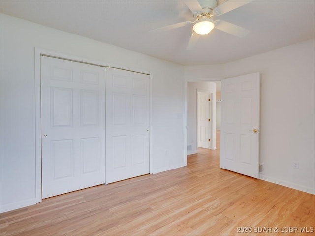 unfurnished bedroom featuring a closet, baseboards, ceiling fan, and light wood-type flooring