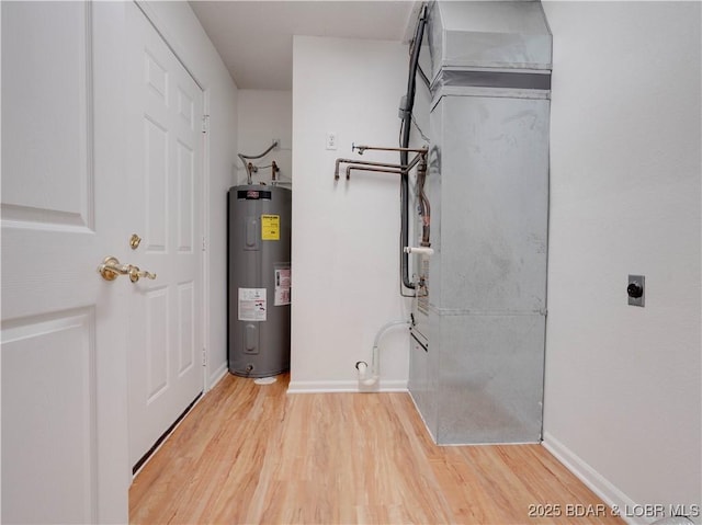 utility room featuring water heater and heating unit