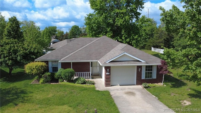 view of front of property with covered porch, a front yard, brick siding, concrete driveway, and an attached garage