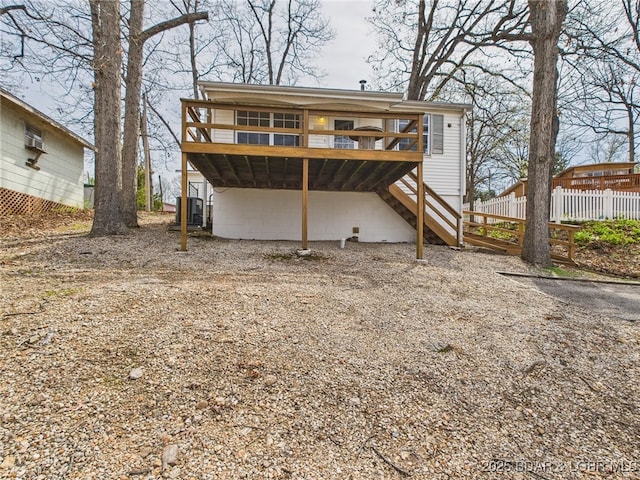 1052 Diggs Rd, Osage Beach, MO 65065 - rear view of property featuring a wooden deck, fence, stairway, and central air condition unit