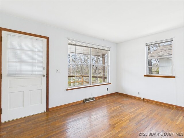 1052 Diggs Rd, Osage Beach, MO 65065 - spare room with wood-type flooring and baseboards