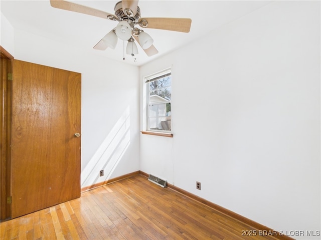 1052 Diggs Rd, Osage Beach, MO 65065 - spare room with hardwood / wood-style flooring, baseboards, and a ceiling fan