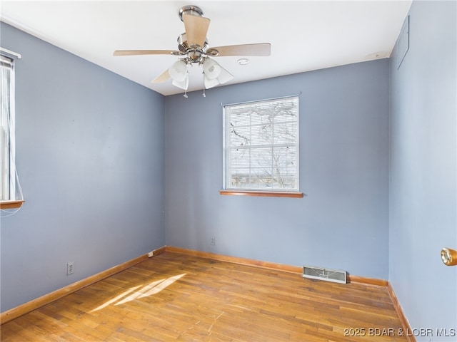 1052 Diggs Rd, Osage Beach, MO 65065 - spare room with wood finished floors, baseboards, and ceiling fan