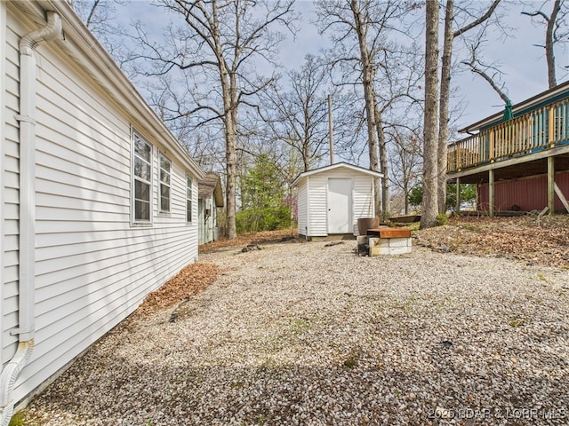 1052 Diggs Rd, Osage Beach, MO 65065 - view of yard with a storage shed, a deck, and an outdoor structure
