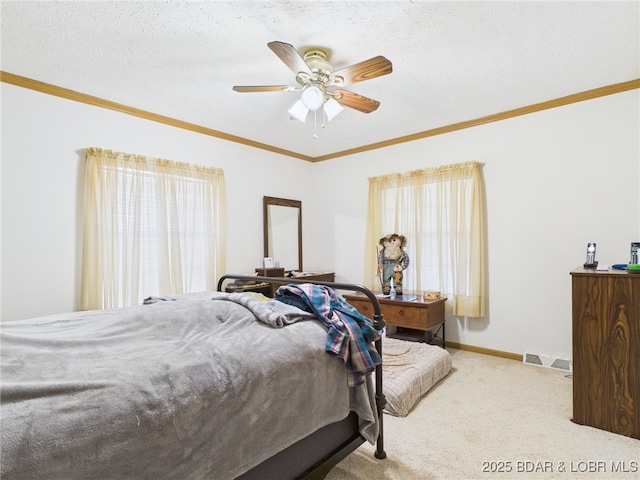 bedroom with visible vents, ornamental molding, carpet floors, baseboards, and ceiling fan